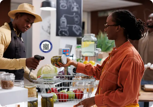A customer paying a merchant for her groceries